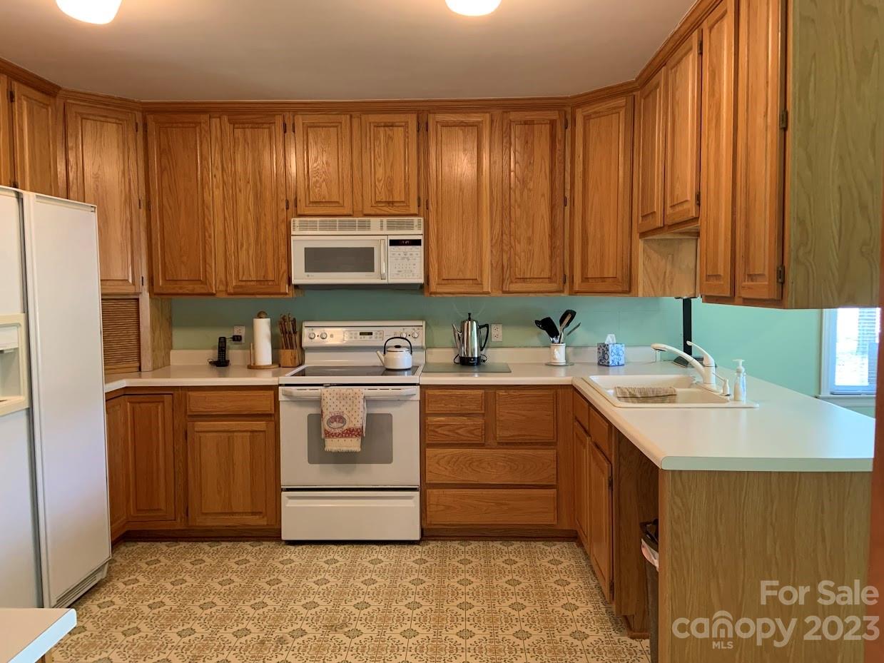 2403 Pinckney Road Chester, SC 29706 - Photo 6 of 19 a kitchen with stainless steel appliances granite countertop a sink a stove a refrigerator and cabinets