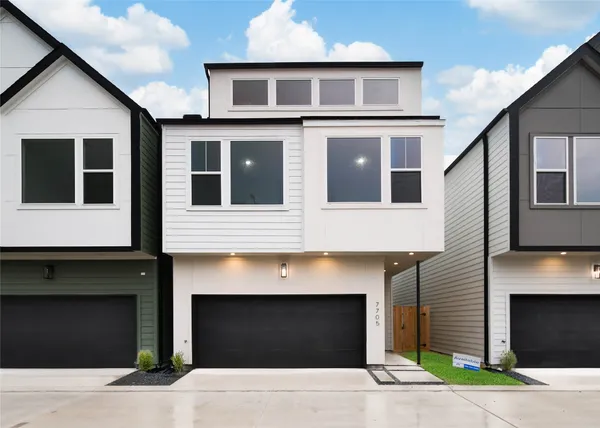 a front view of a house with garage