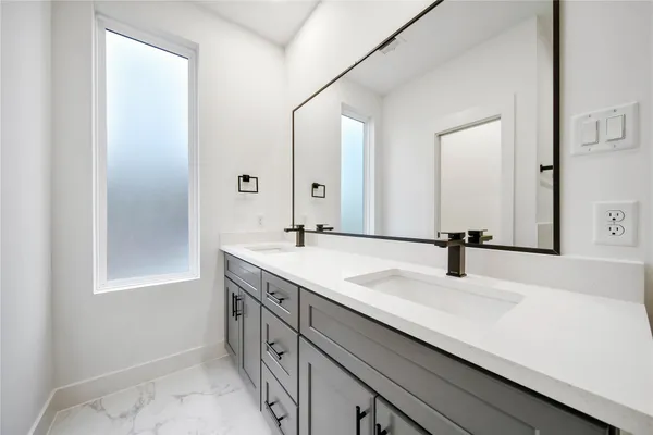 a bathroom with a sink double vanity and a mirror