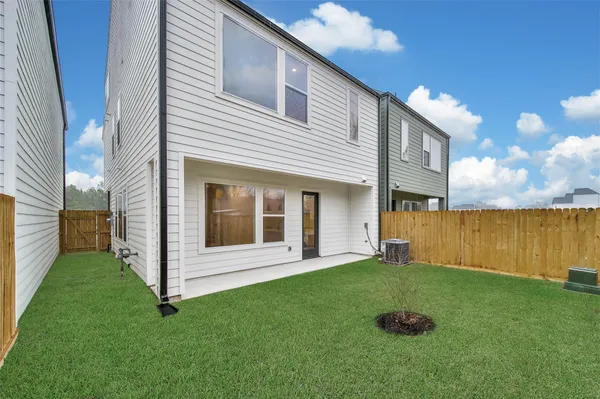 a view of a backyard with plants and a garden