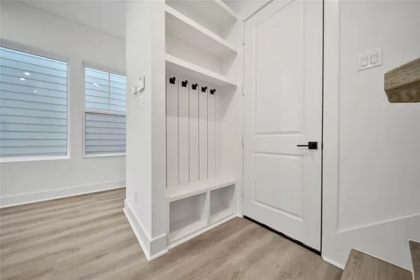 a view of an entryway with wooden floor