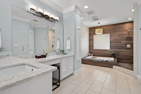 a spacious bathroom with a bathtub sink and mirror