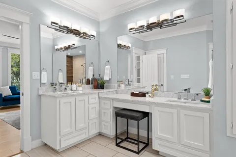 a spacious bathroom with a double vanity sink a mirror and a bathtub