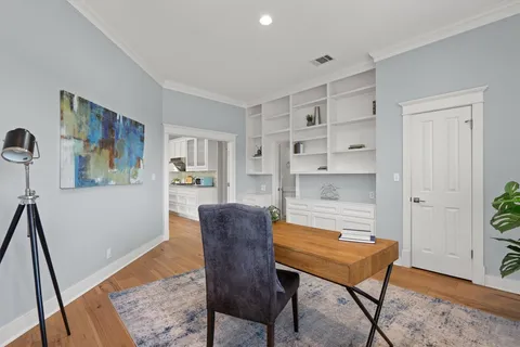 a workspace room with furniture and wooden floor