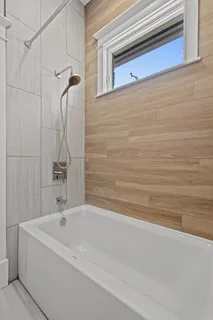 a bathroom with a bathtub and a shower