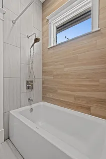 a bathroom with a bathtub and a shower