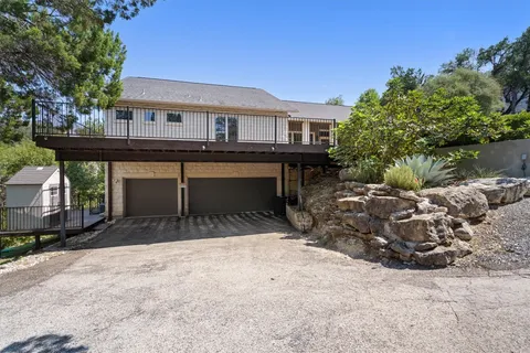 a view of house with backyard and sitting area