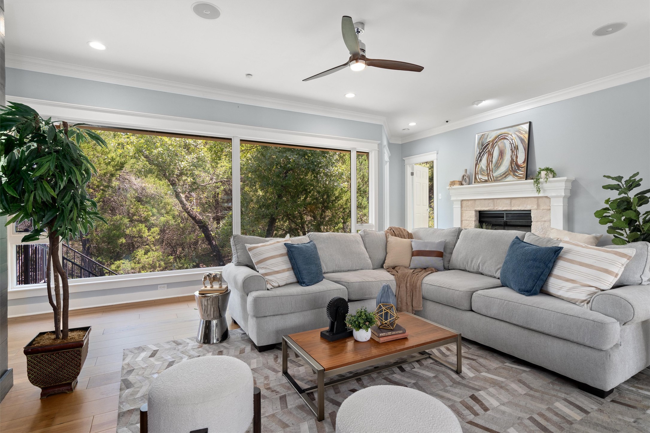 6405 Culpepper Cove Austin, TX 78730 - Photo 7 of 40 Living room with crown molding, a fireplace, a ceiling fan, wood finished floors, and recessed lighting