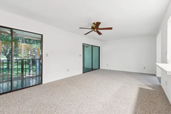 a view of room with a ceiling fan and window