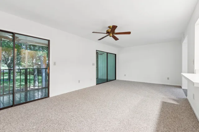 a view of room with a ceiling fan and window