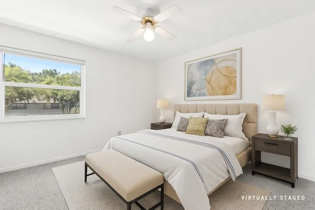 a bedroom with a bed and a window