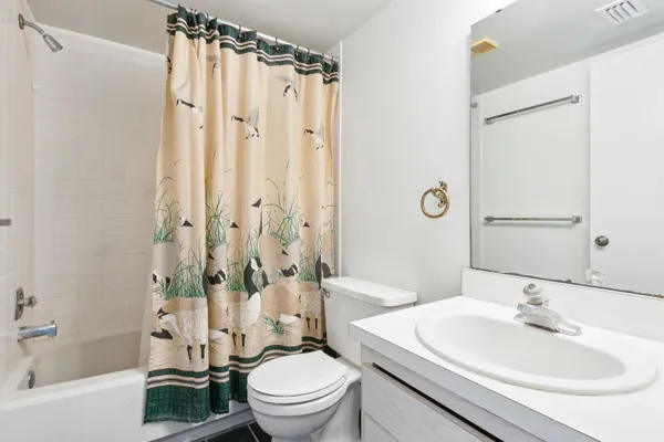 a bedroom with a bed and a potted plant