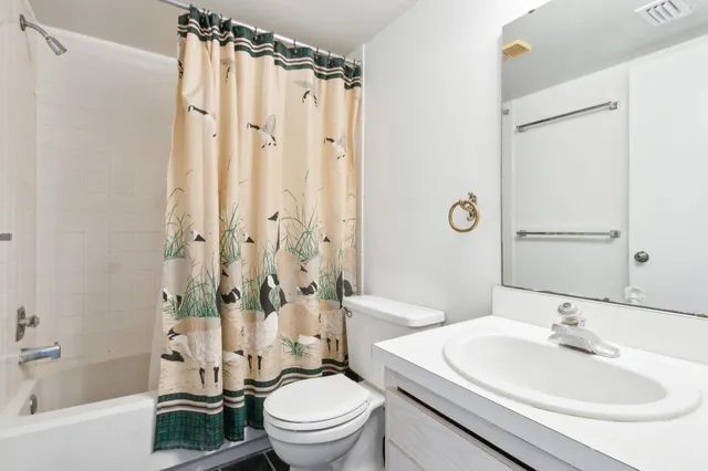 a bedroom with a bed and a potted plant