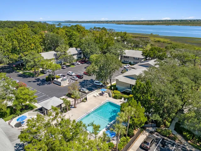 an aerial view of residential houses with outdoor space and swimming pool