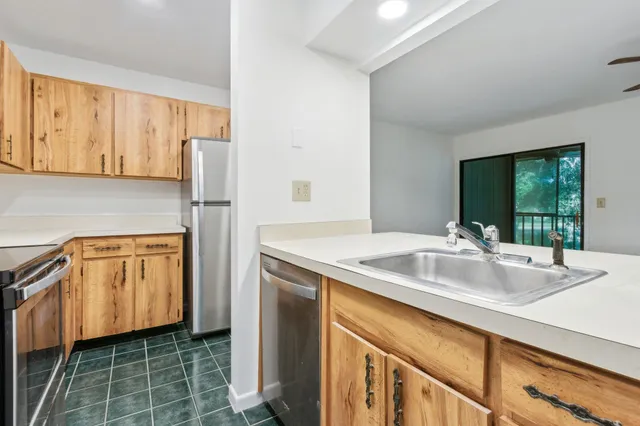 a kitchen with a sink stove and refrigerator