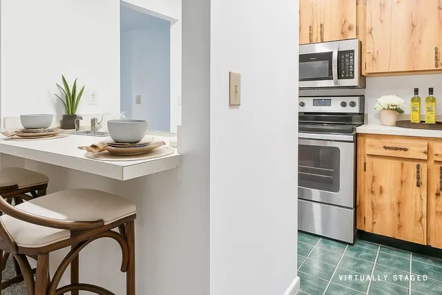 a kitchen with stainless steel appliances a stove a sink and a refrigerator