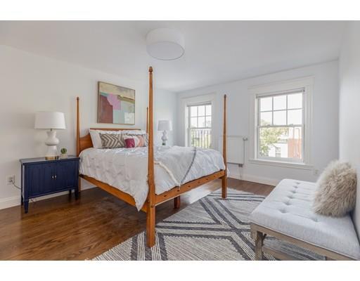 44 Harvard Street Boston, MA 02129 - Photo 11 of 19 a bedroom with a bed and wooden floor