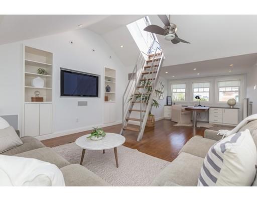 44 Harvard Street Boston, MA 02129 - Photo 12 of 19 a living room with furniture a flat screen tv and a dining table