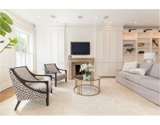 44 Harvard Street Boston, MA 02129 - Photo 2 of 19 a living room with furniture a flat screen tv and a fireplace