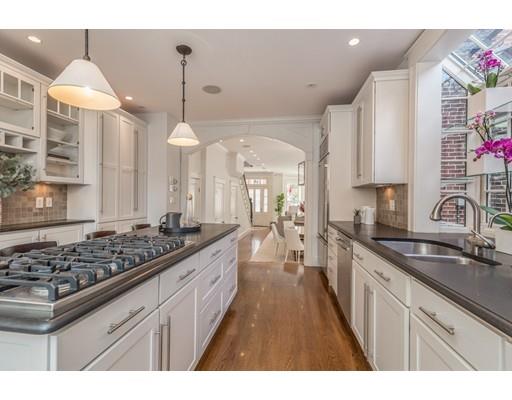 44 Harvard Street Boston, MA 02129 - Photo 8 of 19 a kitchen with stainless steel appliances a stove a sink a refrigerator and cabinets