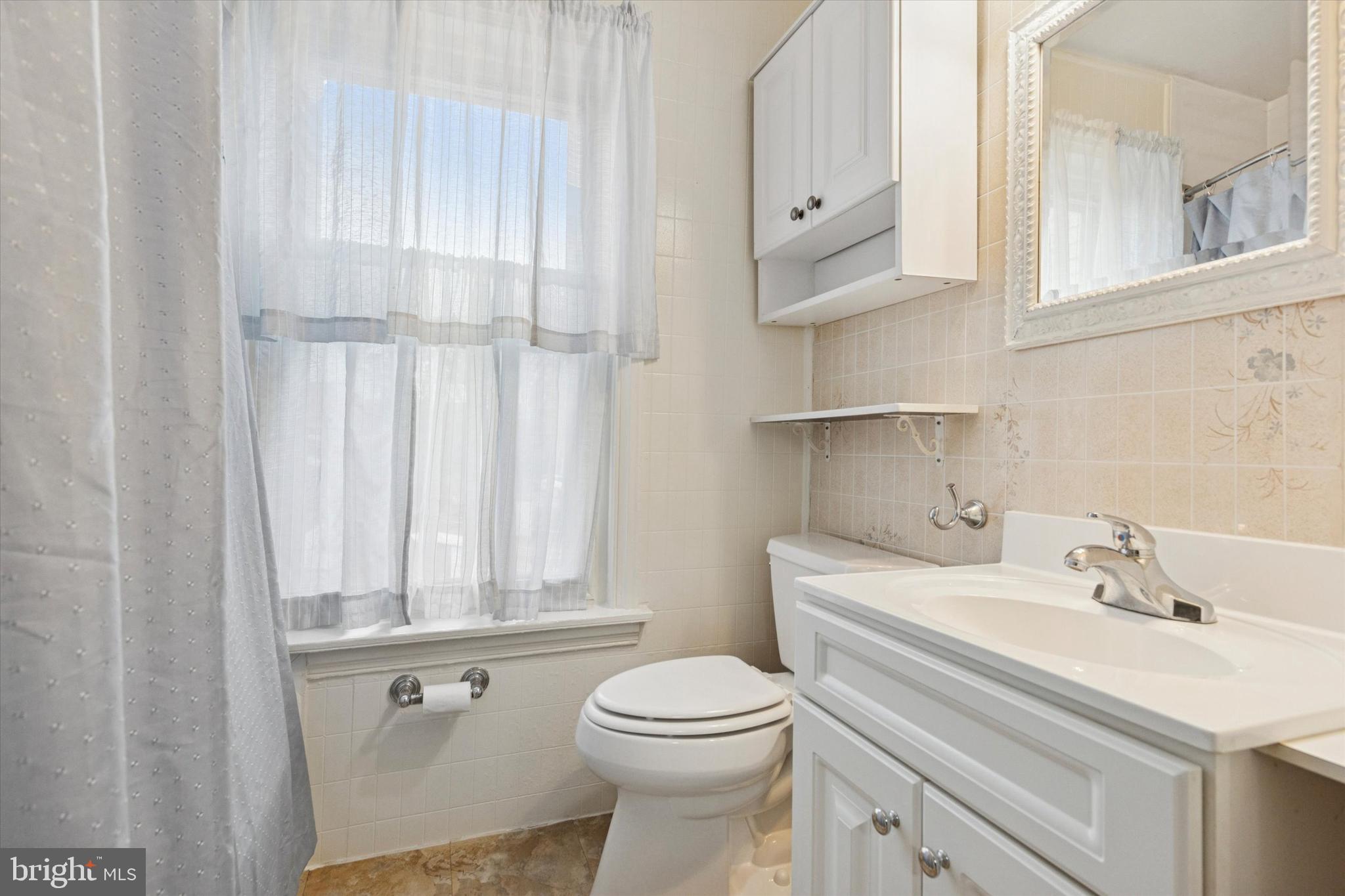 218 Bullock Avenue Conshohocken, PA 19428 - Photo 9 of 16 a bathroom with a sink a toilet and vanity