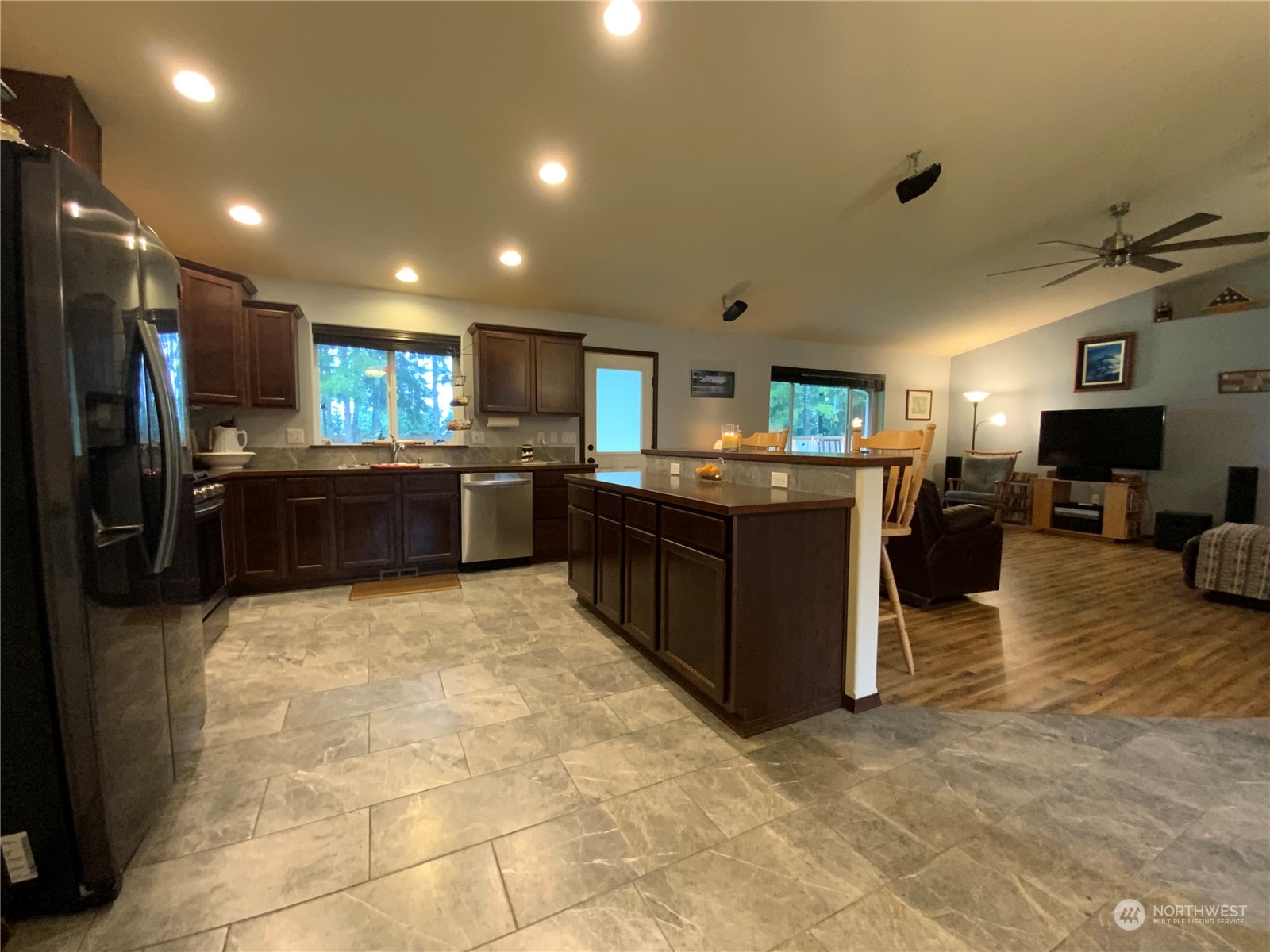 5126 180th Trail Southwest Rochester, WA 98579 - Photo 4 of 35 a kitchen with stainless steel appliances granite countertop a refrigerator and a stove top oven with wooden floors