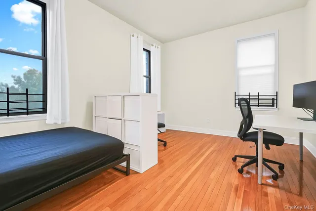 a view of a room with wooden floor and lounge chair