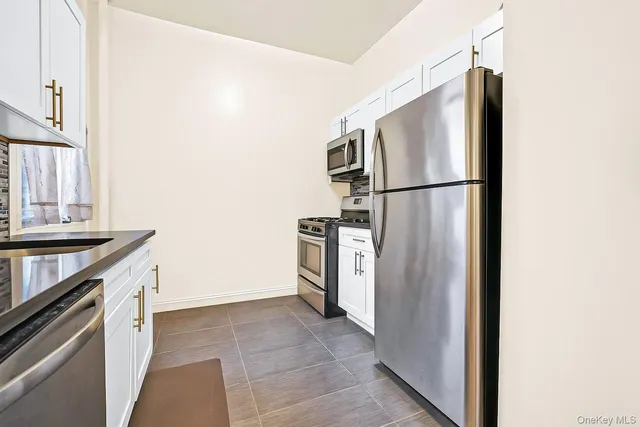 a kitchen with a refrigerator sink and stove