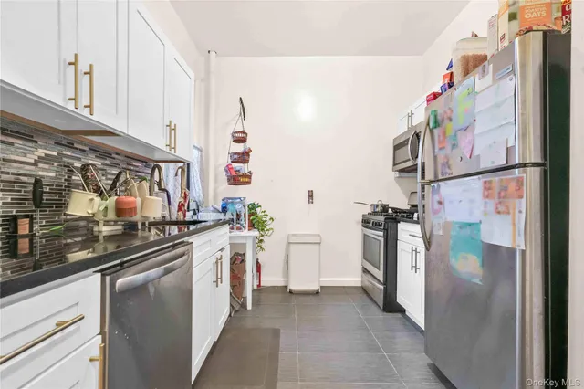 a kitchen with a refrigerator and cabinets