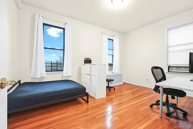a living room with a bed furniture and a window