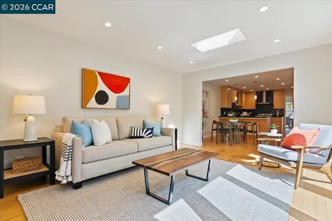 a living room with furniture and kitchen view
