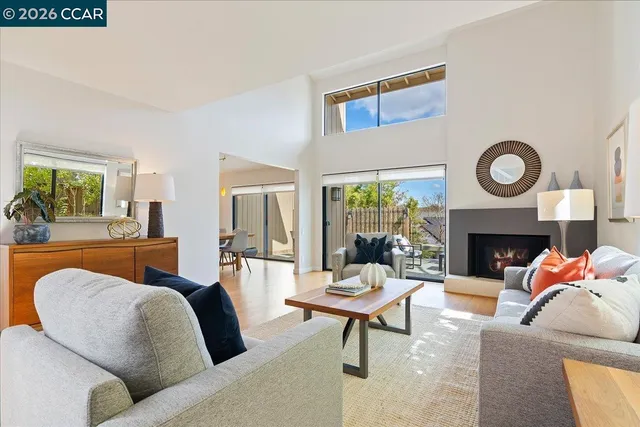 a living room with furniture a fireplace and a window
