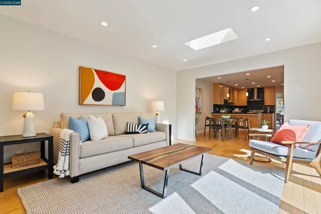 a living room with furniture and kitchen view