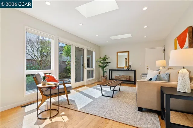 a reading room with furniture and floor to ceiling window