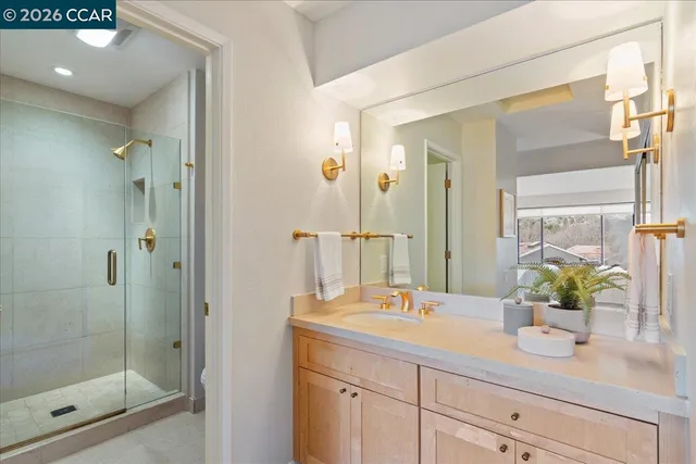 a bathroom with a shower sink and mirror