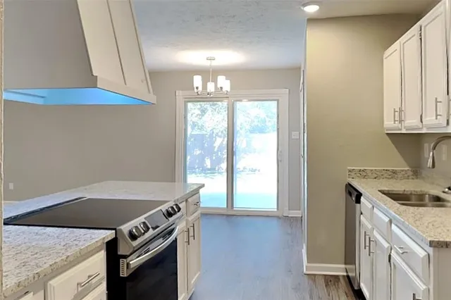 a kitchen with a stove and a white refrigerator