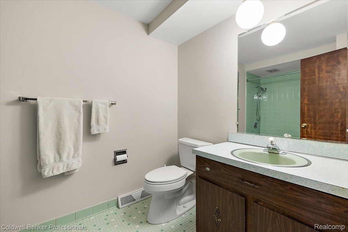 78 Carter Avenue Troy, MI 48098 - Photo 31 of 52 Bathroom featuring vanity, tile patterned floors, and a tile shower