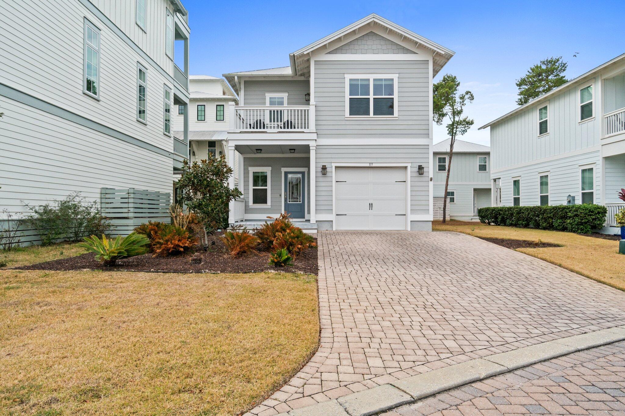 89 Grande Pointe Drive Inlet Beach, FL 32461 - Photo 1 of 47 a front view of a house with a yard and potted plants