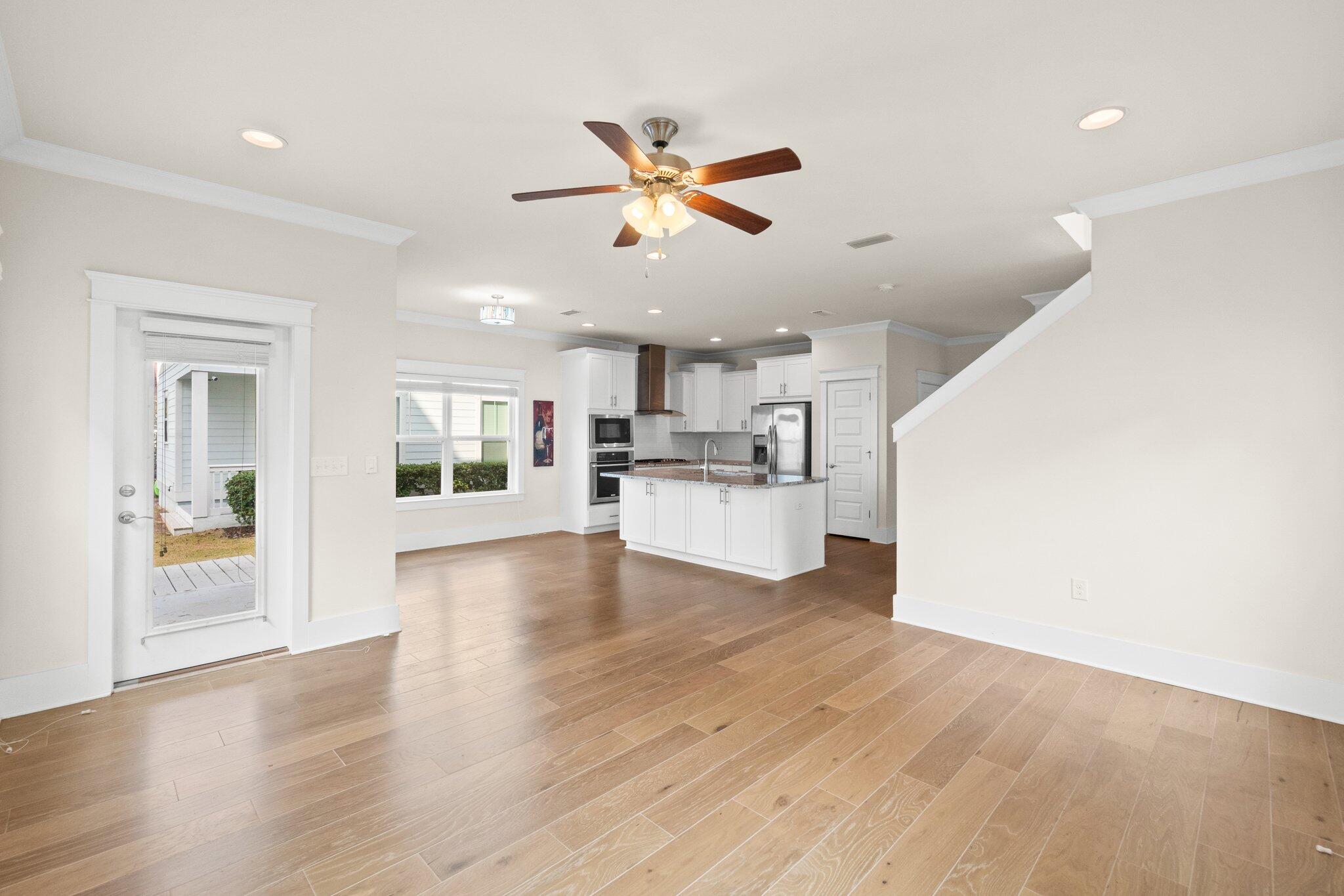 89 Grande Pointe Drive Inlet Beach, FL 32461 - Photo 13 of 47 a view of a kitchen with wooden floor and a ceiling fan