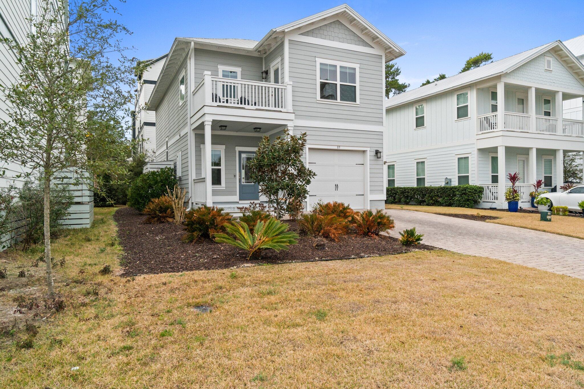 89 Grande Pointe Drive Inlet Beach, FL 32461 - Photo 2 of 47 a view of a white house with large windows next to a road