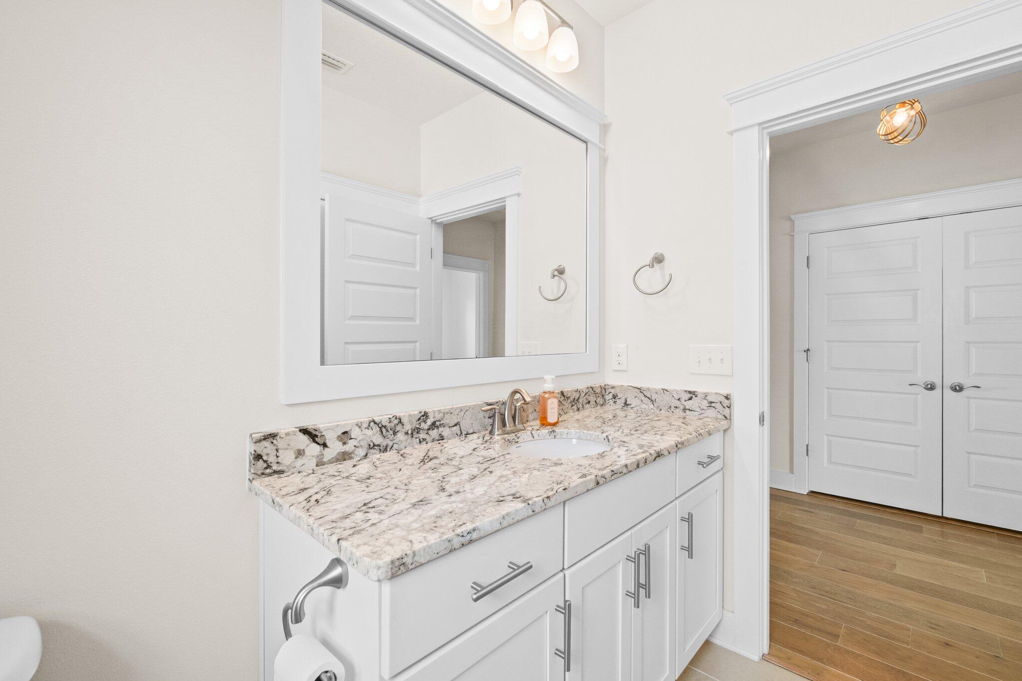 89 Grande Pointe Drive Inlet Beach, FL 32461 - Photo 23 of 47 a bathroom with a granite countertop sink and a mirror