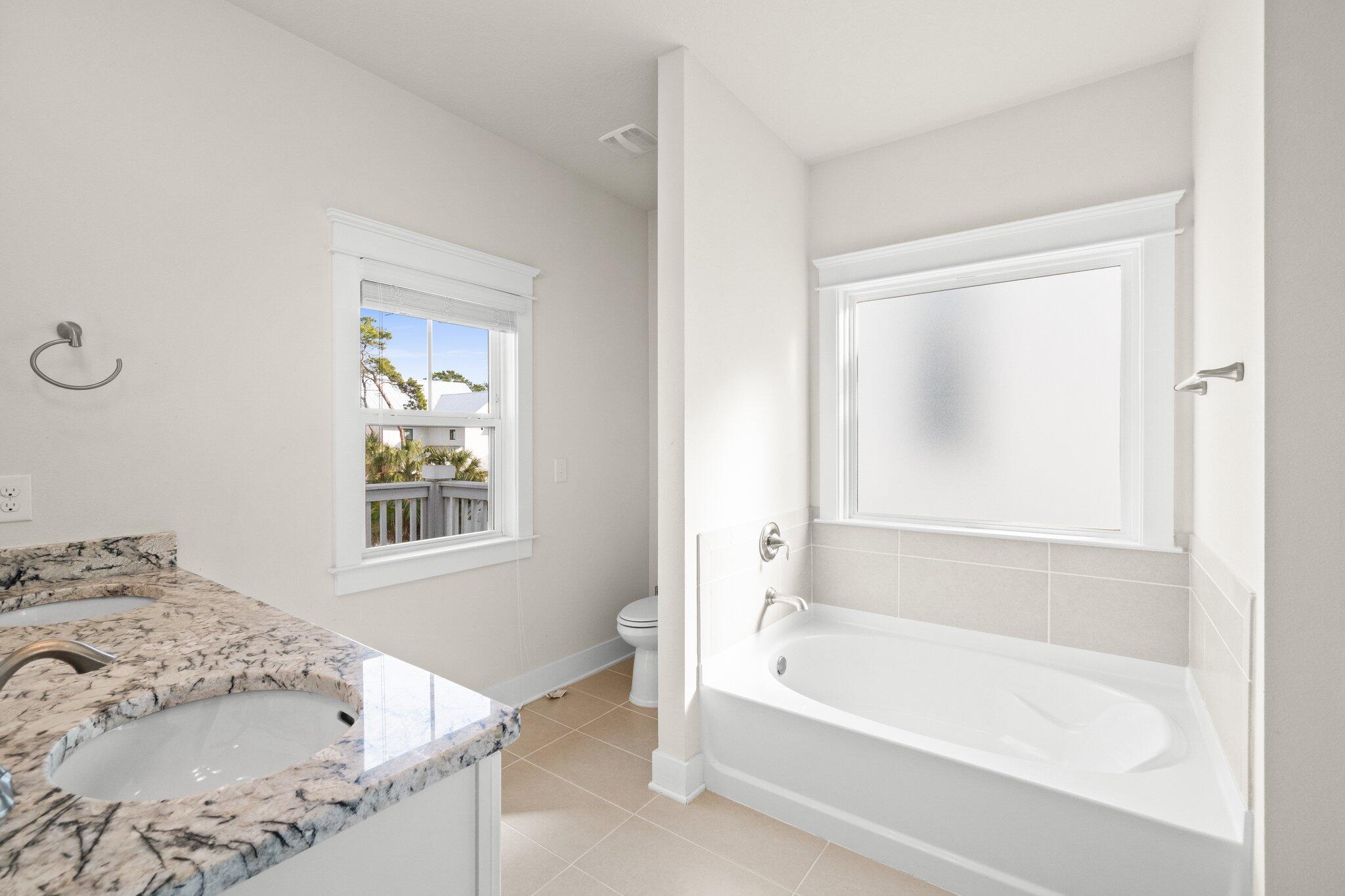 89 Grande Pointe Drive Inlet Beach, FL 32461 - Photo 26 of 47 a bathroom with a tub and a window