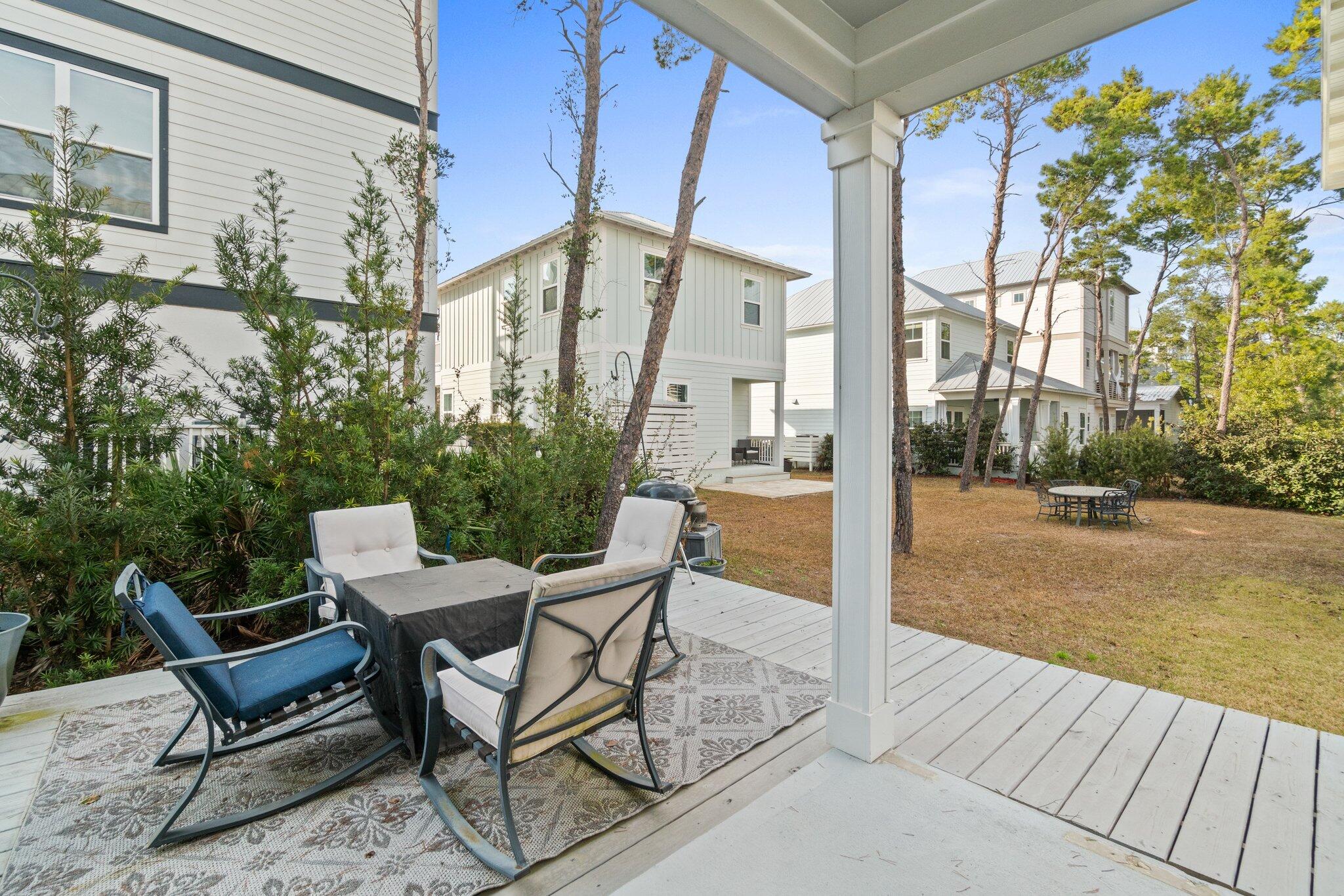 89 Grande Pointe Drive Inlet Beach, FL 32461 - Photo 29 of 47 a view of a balcony with table and chairs and potted plants