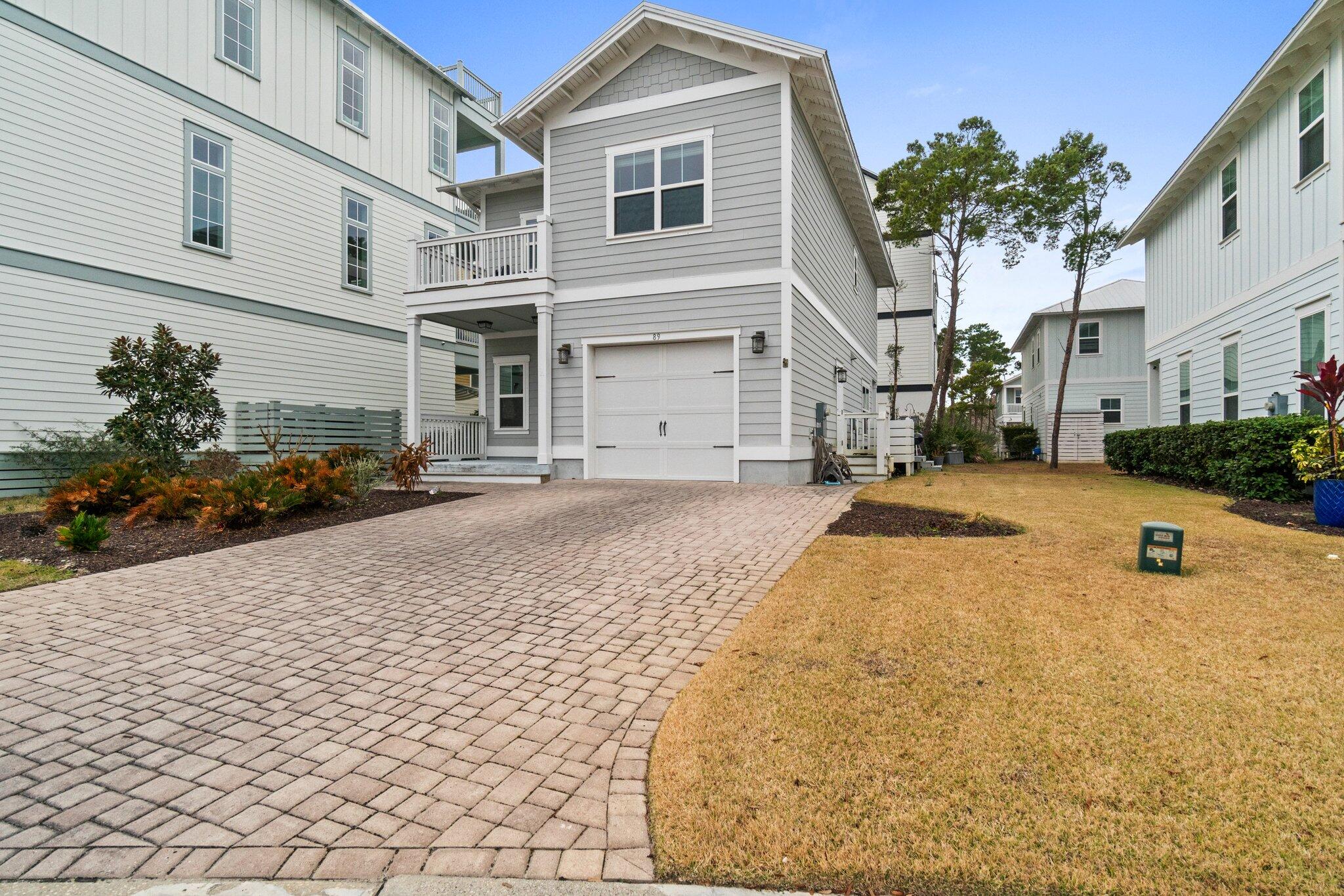 89 Grande Pointe Drive Inlet Beach, FL 32461 - Photo 3 of 47 a front view of a house with a yard and garage