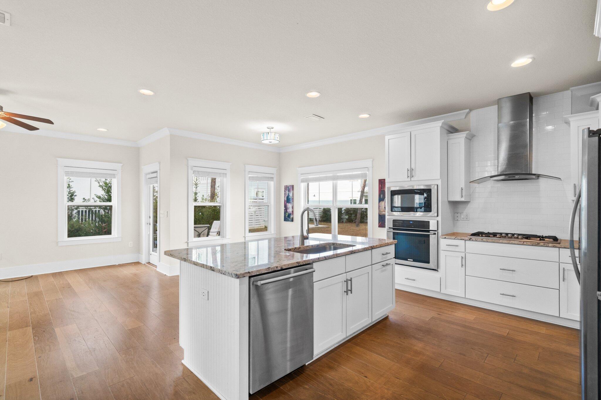 89 Grande Pointe Drive Inlet Beach, FL 32461 - Photo 5 of 47 a kitchen with white cabinets and white appliances