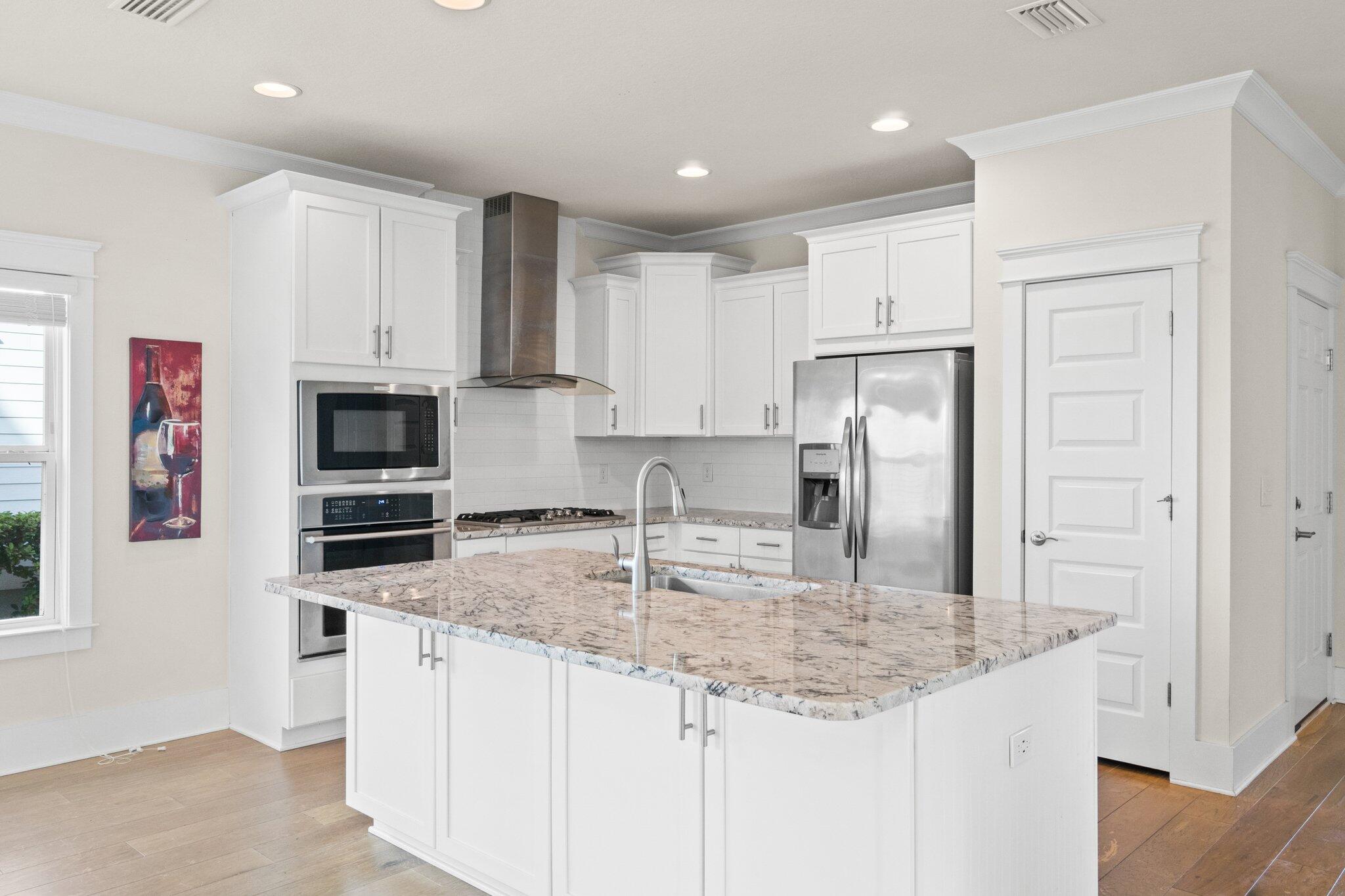 89 Grande Pointe Drive Inlet Beach, FL 32461 - Photo 6 of 47 a kitchen with kitchen island granite countertop a stove sink and refrigerator