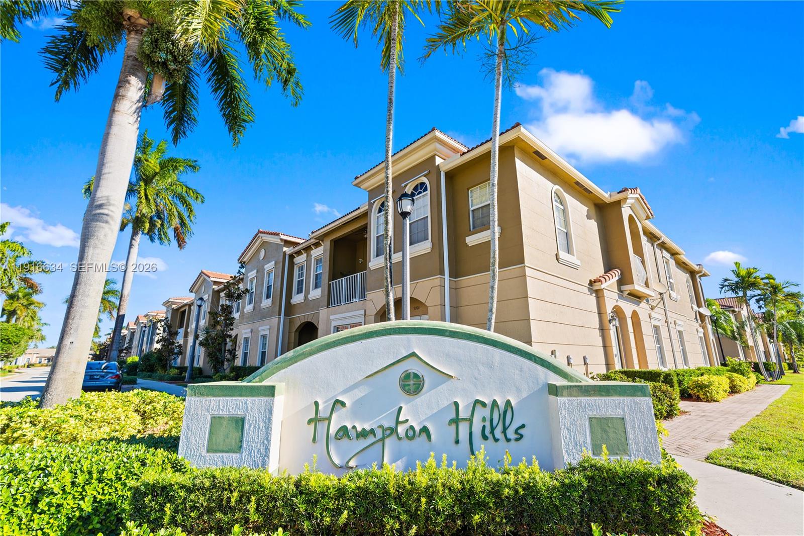 5850 Hampton Hills Boulevard, Unit 5850 Tamarac, FL 33321 - Photo 17 of 22 a front view of a multi story residential apartment building with entryway