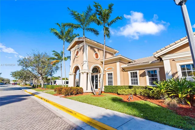 a view of a living room with furniture and potted plants