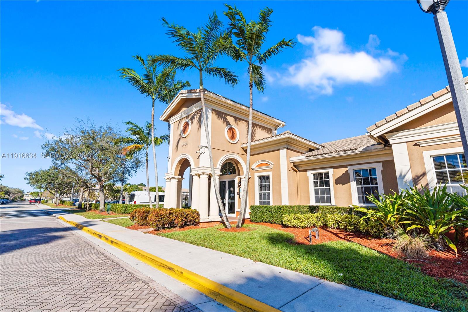 5850 Hampton Hills Boulevard, Unit 5850 Tamarac, FL 33321 - Photo 18 of 22 a front view of a house with a yard