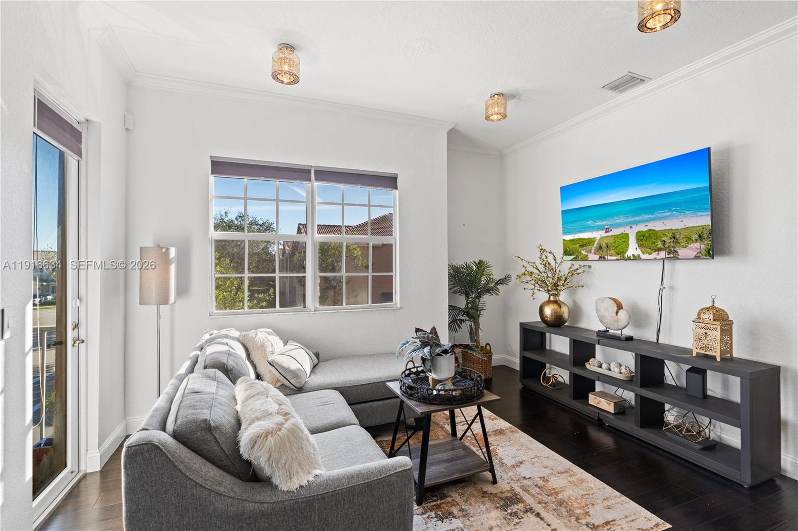 5850 Hampton Hills Boulevard, Unit 5850 Tamarac, FL 33321 - Photo 3 of 22 a living room with furniture a rug and a window